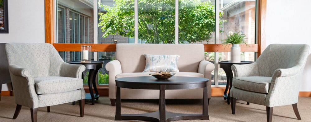 Bright and inviting common area with seating and view of greenery