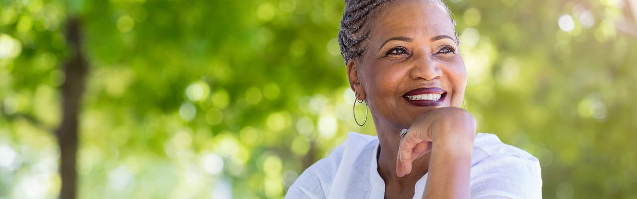 Smiling senior woman outdoors in a garden setting