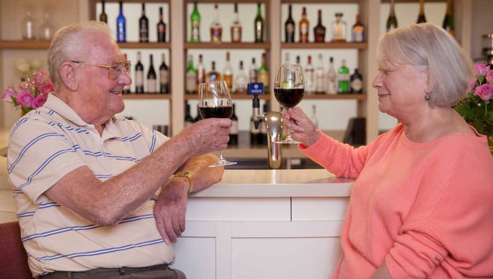 Residents toasting with wine glasses in a social setting