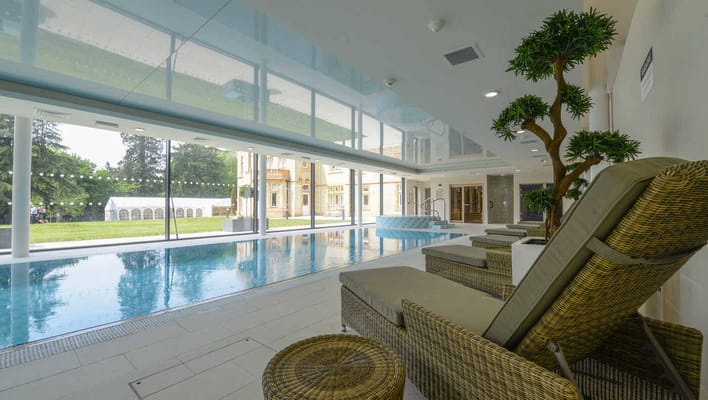 Indoor swimming pool area with seating