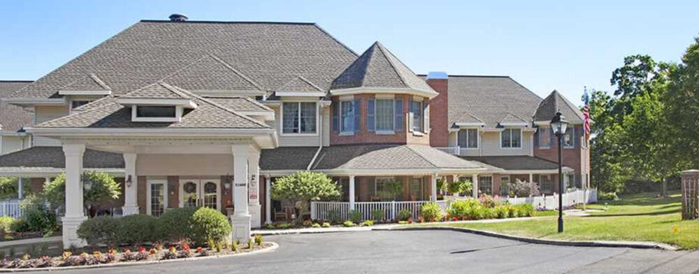 Exterior view of a senior living facility with gardens