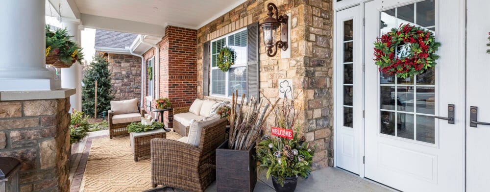 Welcoming outdoor entrance with seating and decorations