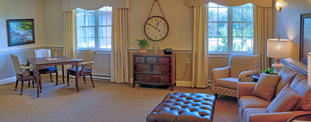 Bright and inviting common area with seating and a clock