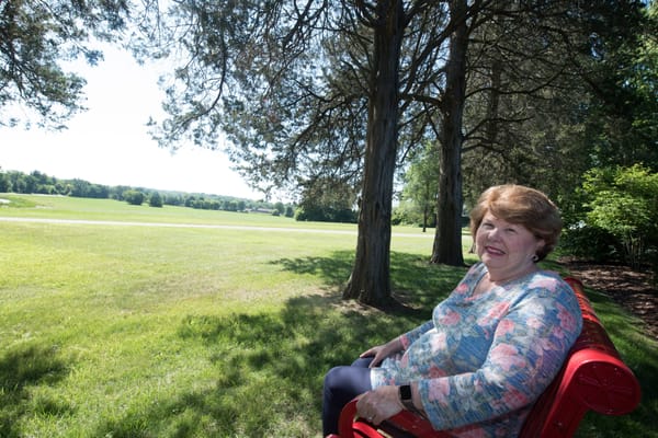 A resident enjoying time outdoors in a sunny park area