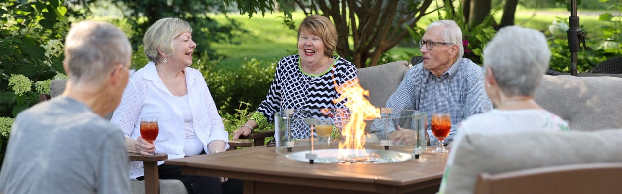Residents enjoying a conversation around a fire pit