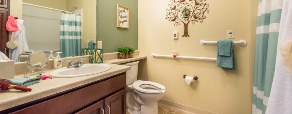 A well-lit bathroom in a senior living facility