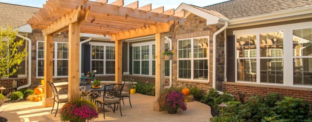 Beautiful outdoor seating area with pergola and flowers