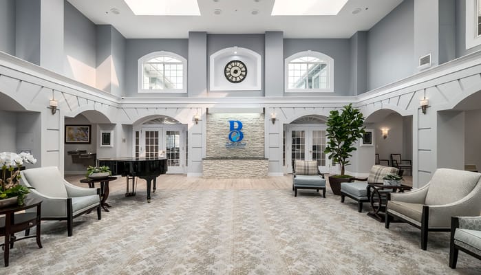 Spacious interior with seating and piano in common area