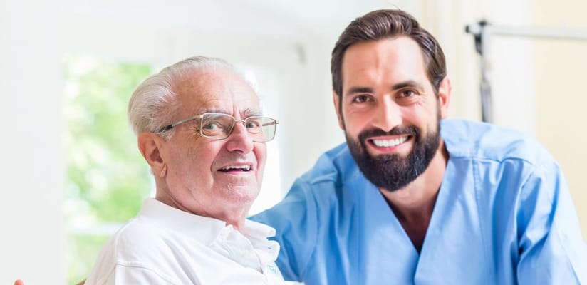 Caregiver and resident smiling together in a facility
