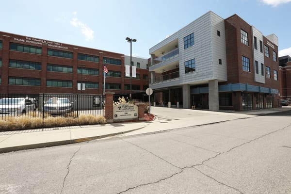 Entrance of Rivertown Assisted Living Apartments with sign and building facade