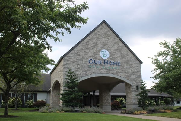 Exterior view of Our Home New Albany with trees and shrubs