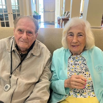 Residents engaging in conversation on a couch