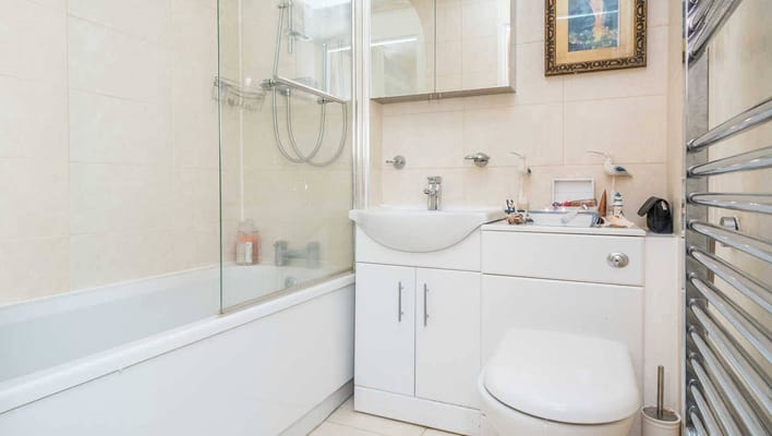 Bright and clean bathroom with shower and sink.