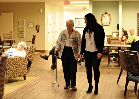 Staff assisting a resident in a common area
