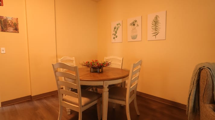 Dining table with floral centerpiece in a warm-colored room