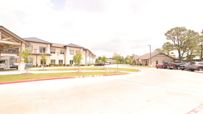 Exterior view showing the driveway and surrounding buildings of StoneCreek of Copperfield.