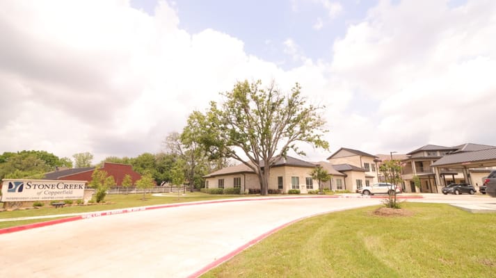 Exterior view showcasing the entrance and signage of StoneCreek of Copperfield Senior Living.