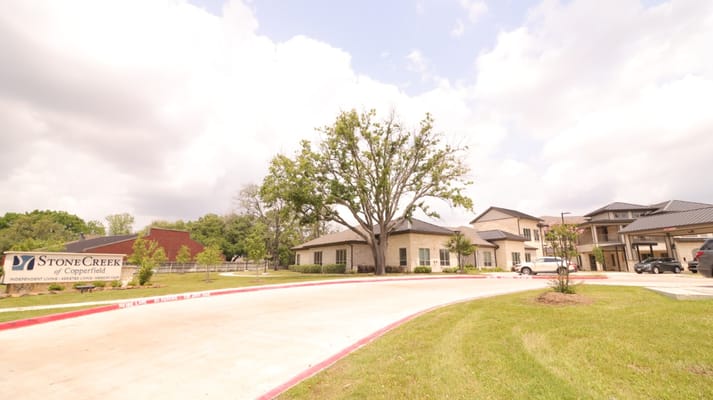 Entrance view of StoneCreek of Copperfield with landscaping.