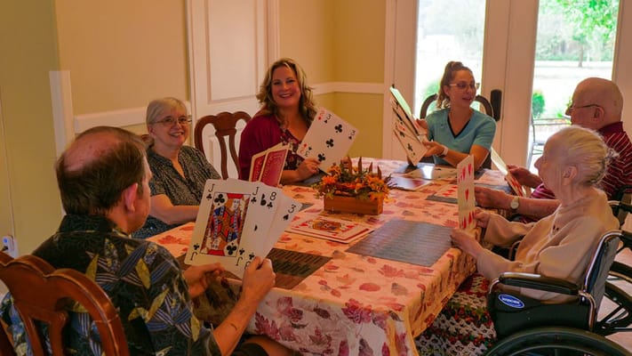 Residents enjoying a card game in a common area