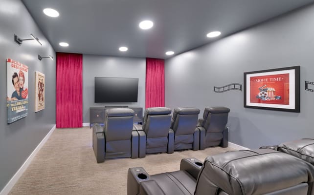 Cozy movie theater room with reclining chairs