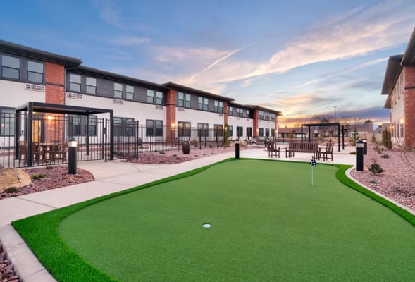 Outdoor recreational area with putting green and seating