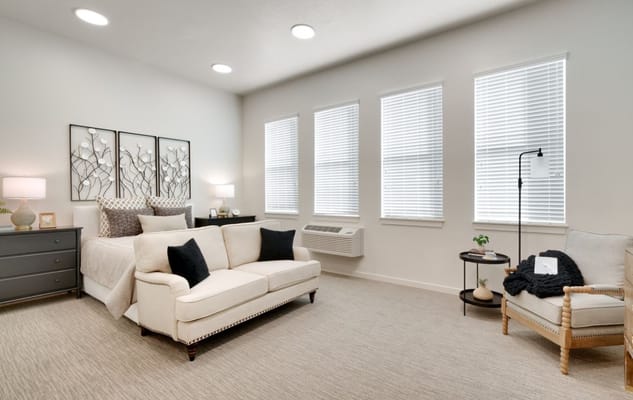 Bright interior of a private resident room with a sofa