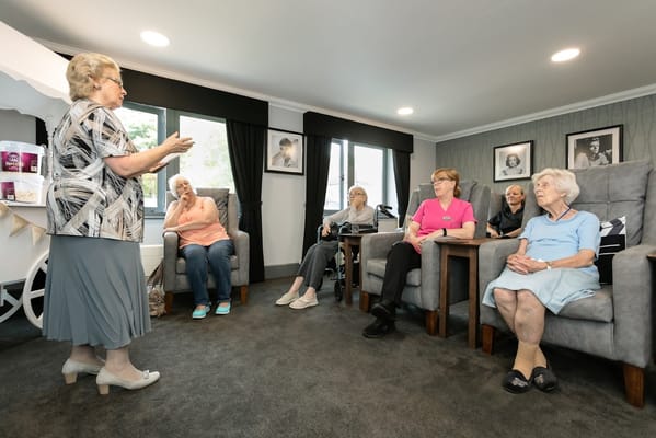 Residents engaged in an activity session in a cozy common area