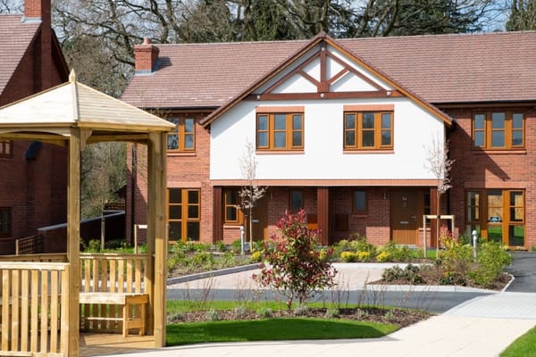 Exterior view of a senior living facility with landscaping