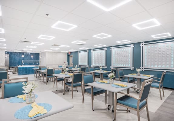 Bright dining room with tables set for meals