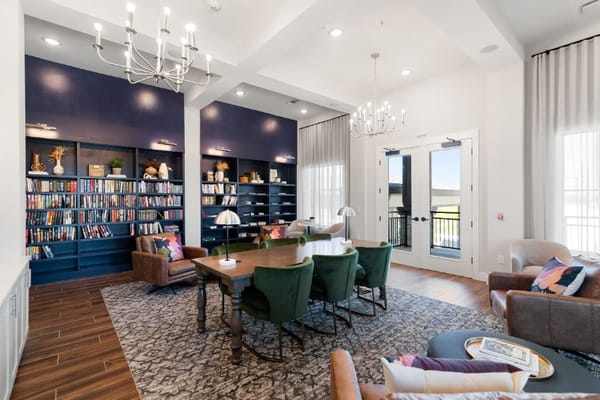 Bright library area with bookshelves and a communal table