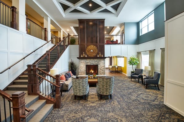 Bright interior common area with seating and fireplace
