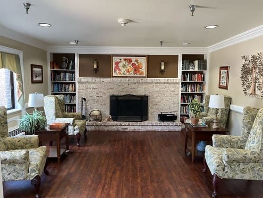 Cozy common area with armchairs and bookshelves
