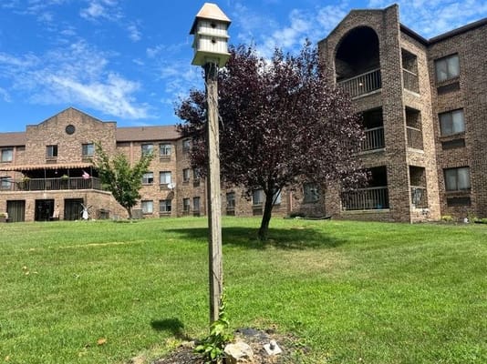 Outdoor view of the senior living facility's exterior with green space