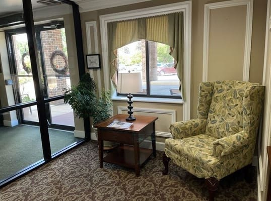 Cozy lobby area with armchair and window