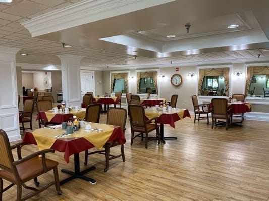 Bright dining room with set tables and food service