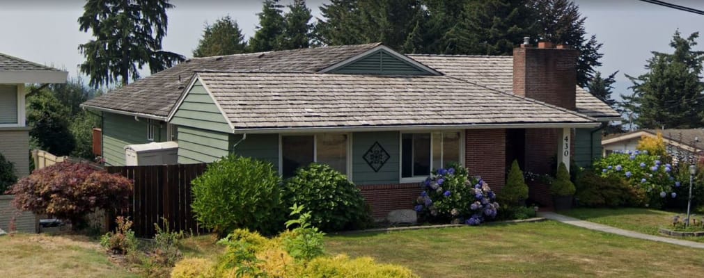 Exterior of Amy's Adult Care Home with lush greenery and flowers