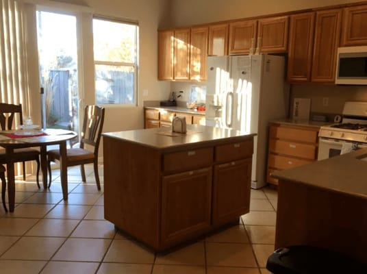 Bright kitchen area with wooden cabinets and table