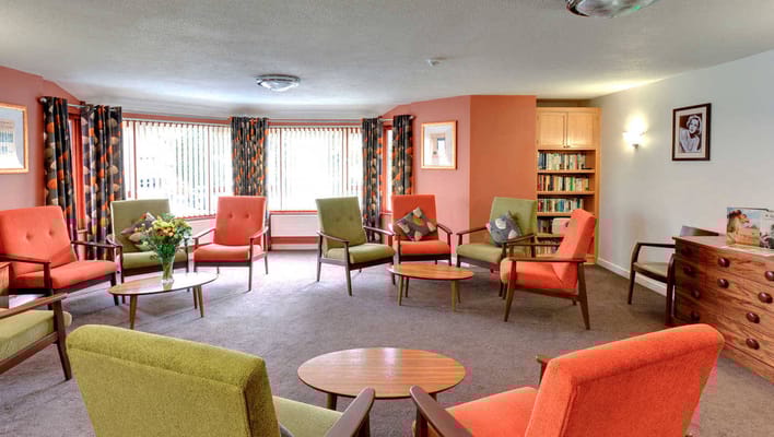 Bright common area with colorful seating and bookshelves