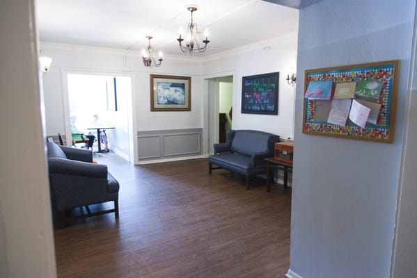 Interior view of a common area with seating and residents