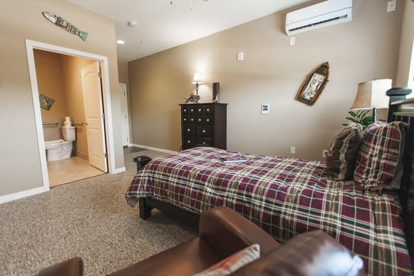 Cozy private room with a plaid blanket and armchair