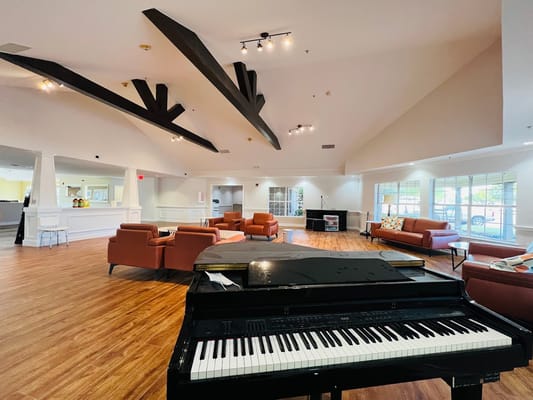 Interior view of a common area with seating and a piano