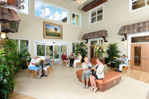 Residents socializing in a bright, welcoming common area