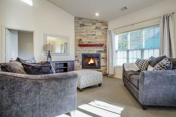 A cozy living room with a fireplace and comfortable seating.