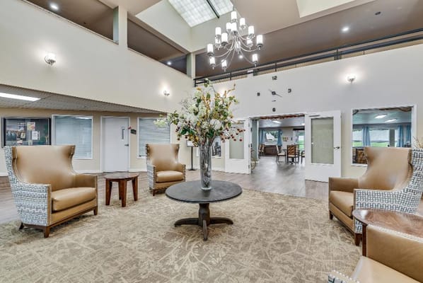 Cozy lobby area with seating and floral arrangement