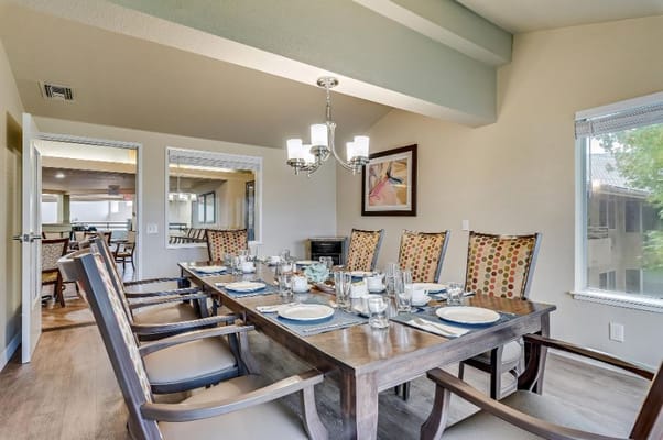 A well-set dining table in a spacious dining room.