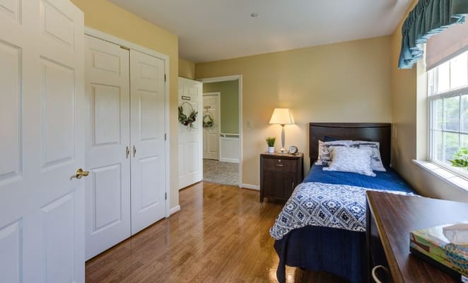 Private room with a bed and dresser