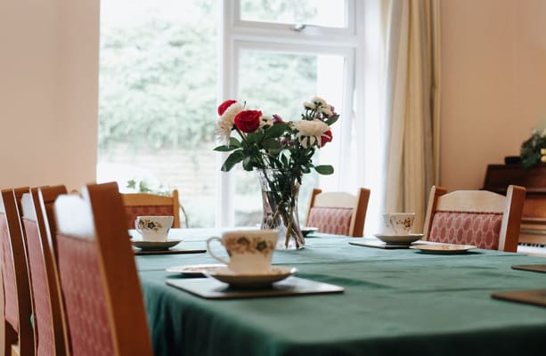 Dining table set with flowers and teacups