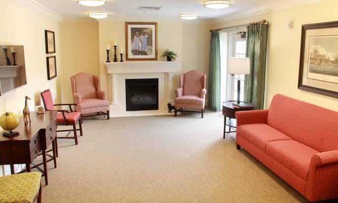 Bright common area with seating and a fireplace