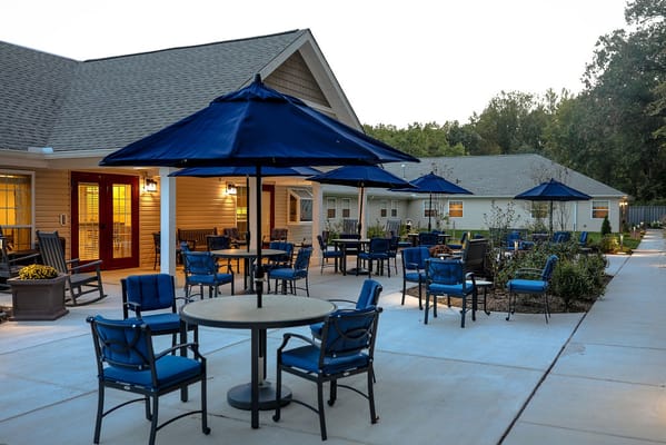 Outdoor seating area with blue umbrellas and chairs