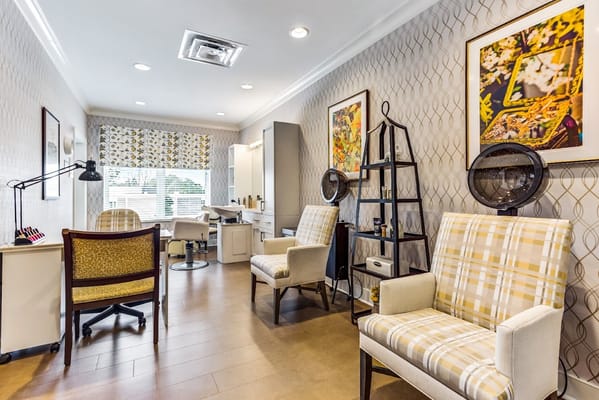 Interior view of a salon area with chairs and decor